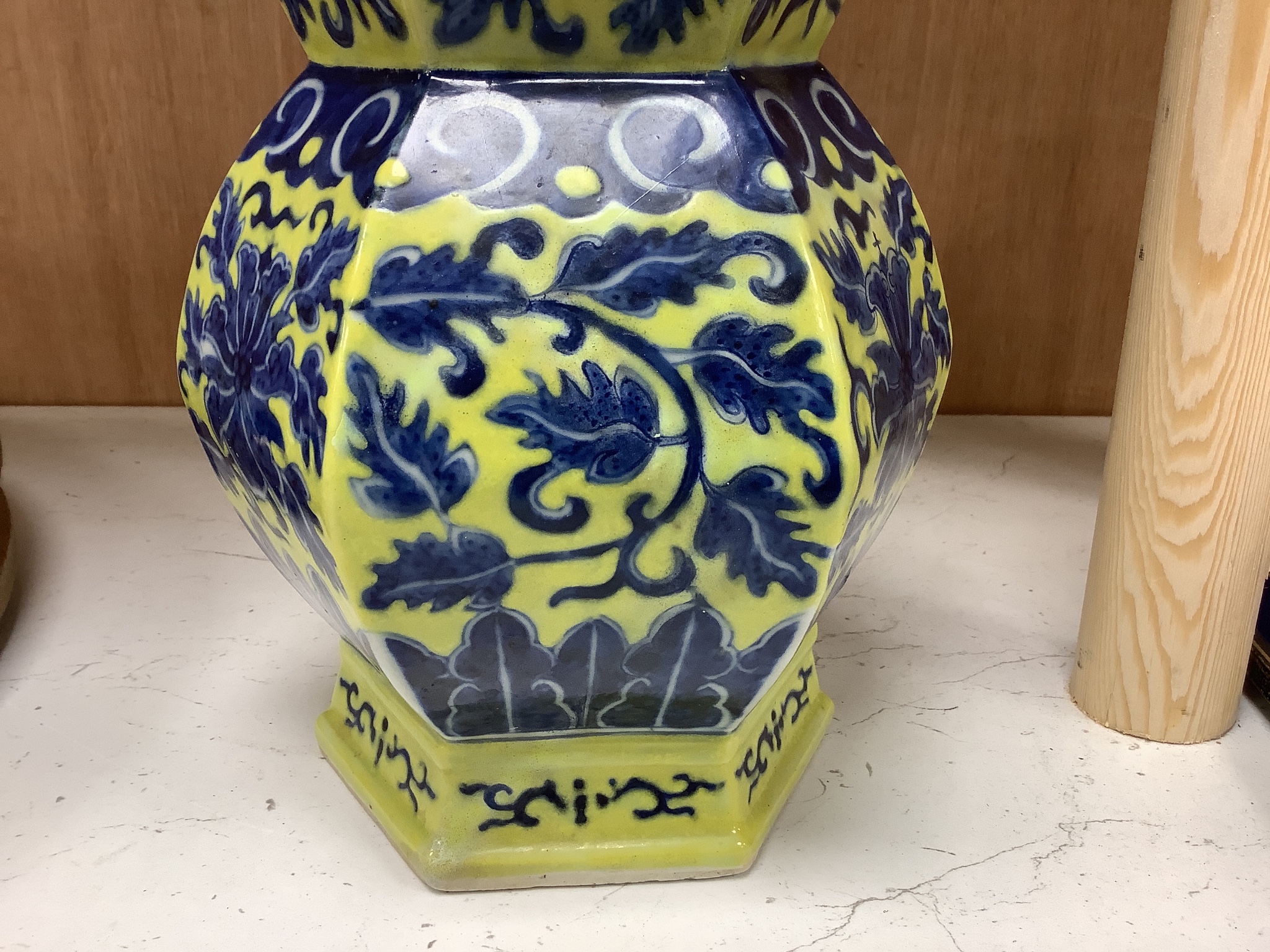 A Chinese underglaze blue yellow ground hexagonal vase, early 20th century, some restoration 35cm